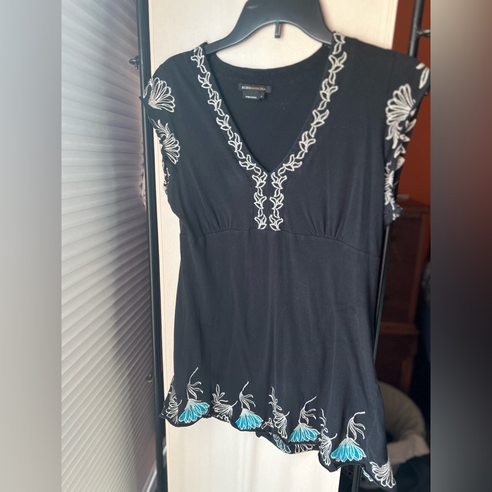 Black top with white and blue embroidery. Size large